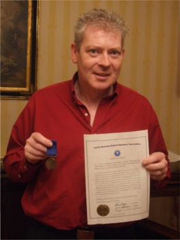 Retired Garda Richard Crowley with his Liddy Medal and parchment.