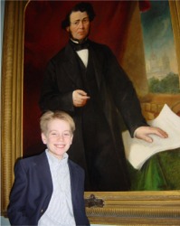 Great, great, great grandson Rodolpe D'Arcy Quinn stands in front of an 1868 painting of Thomas DArcy McGee.
