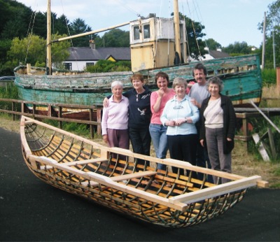 Members of Inishowen cancer Group ist and boat builder Dnal MacPolin, with the skeleton of their currach before it was finished.