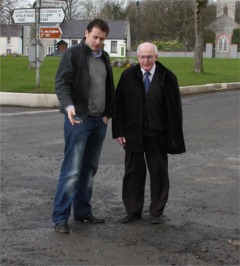 Cllr Dennis McGonagle and local election candidate Charlie McConalogue viewing the damaged road surface in Malin prior to repair work starting this week. 