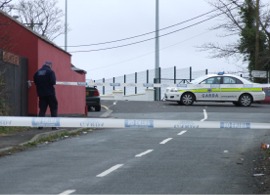 A Garda forensic officer examines the scene at Gleneely following a melee in the early hours of Easter Monday.