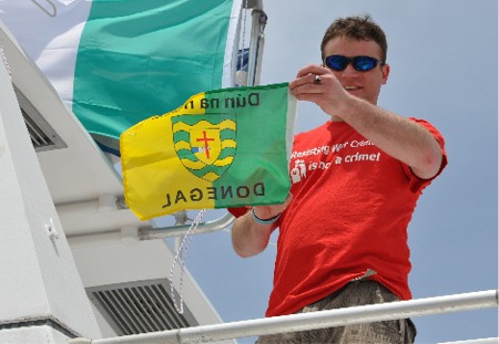 Fiachra  Luain waves a Donegal flag as he joins the Gaza-bound peace flotilla.