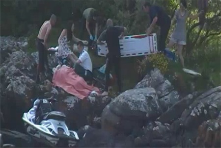 The young teenager is treated by paramedics after a horror jet ski crash at Glenburney beach.