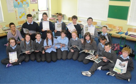 Students from sixth class at Scoil Cholmcille, Newtowncunningham, pictured looking over their school newspaper with teacher Ms Mulligan.