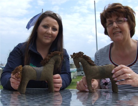 Inishowen Maritime Museum manager, Gemma Havlin, left, receives a donation of two WWII toy horses, from Greencastle publican, Margaret Kealey.
