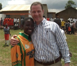 Kevin Cooley pictured with a young student from Precious College, Entebbe, Uganda.