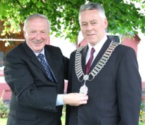 Cllr. Paul Bradley gets the Mayoral chain from outgoing Mayor, Cllr. Joe Doherty.